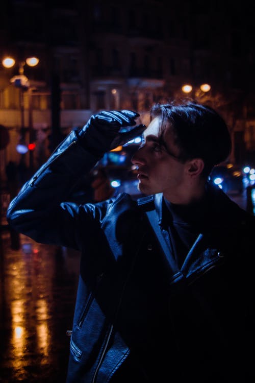 Man in Jacket and Glove at Night