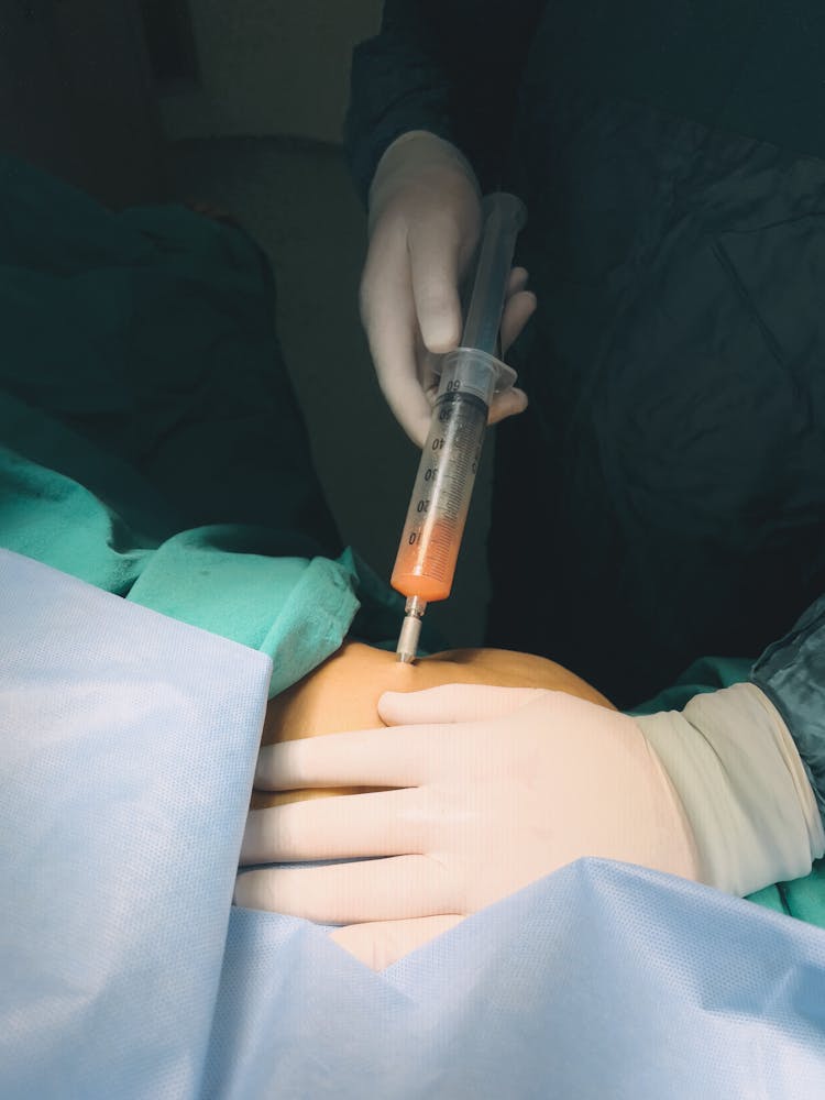 Doctor Hands Applying Syringe To Patient