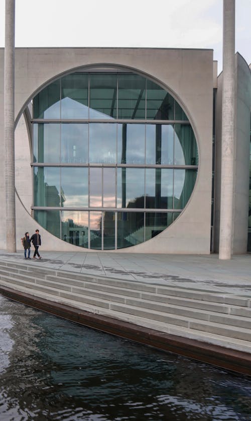 People Walking by Marie-Elisabeth-Lüders-Haus in Berlin, Germany