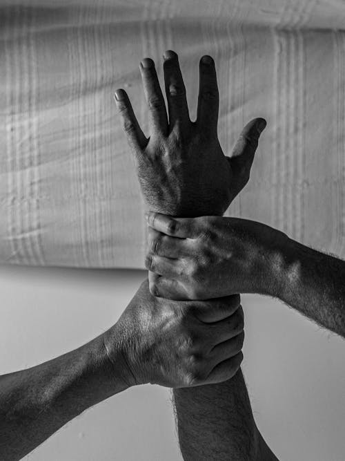 Free Close-up of an Arm Being Held by two Other Hands  Stock Photo