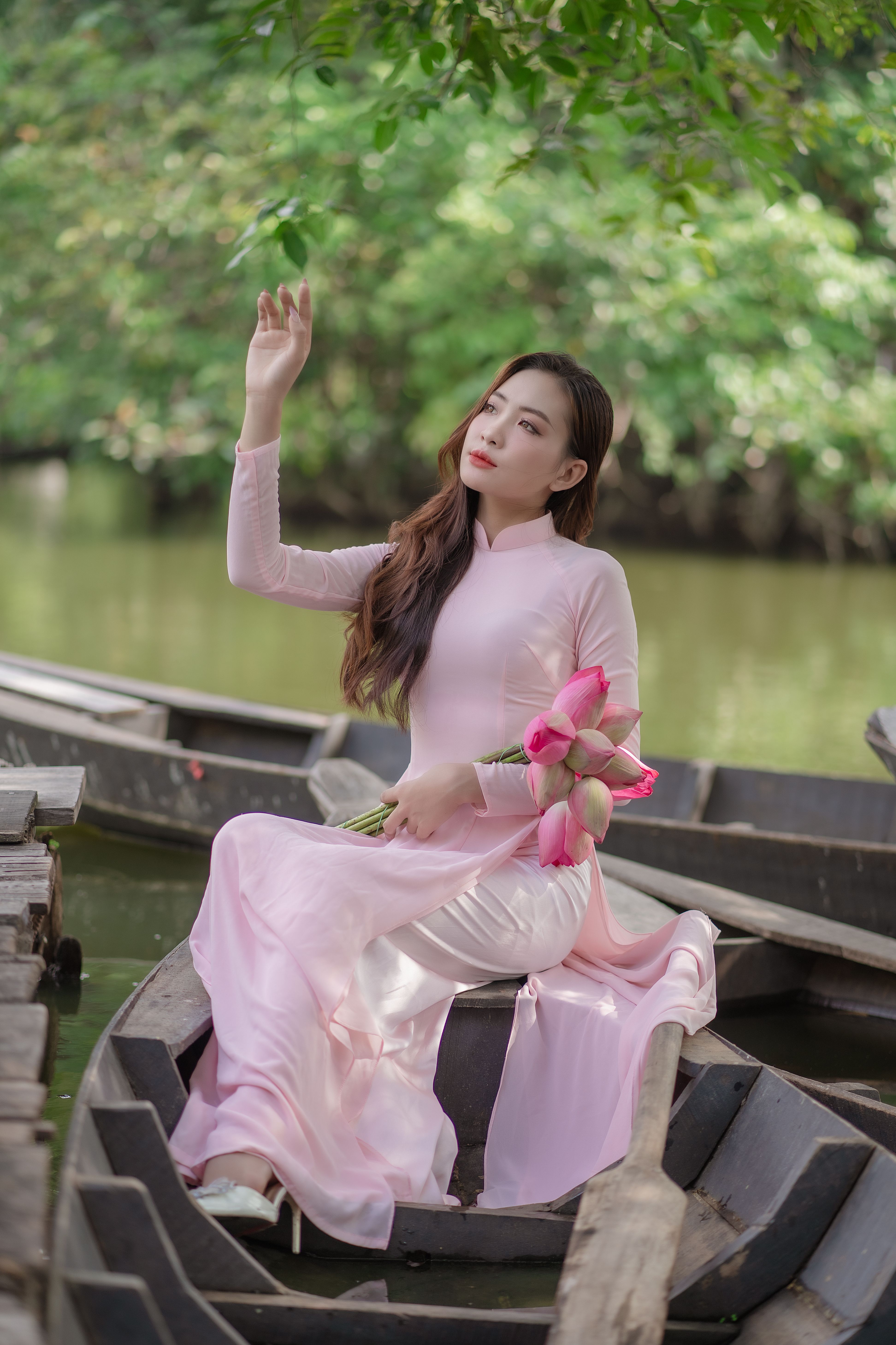 Woman in Pink Dress Sitting with Flowers on Boat · Free Stock Photo