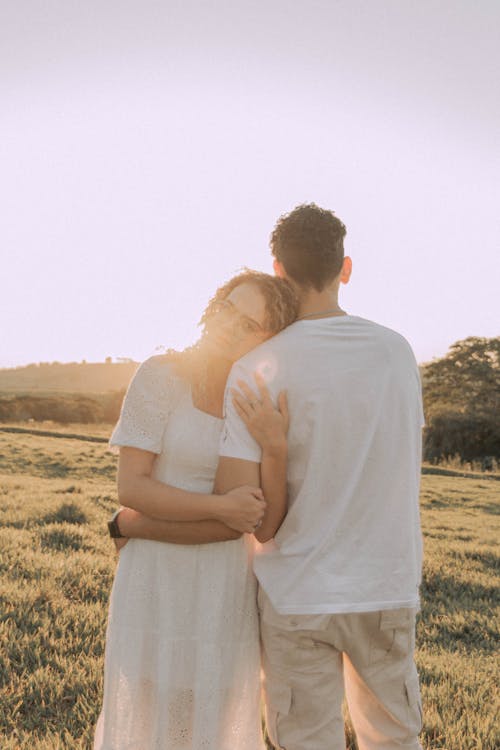 A Couple Standing in a Field