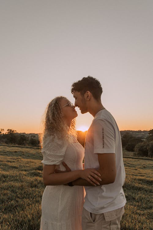 Couple Hugging and Kissing at Sunset