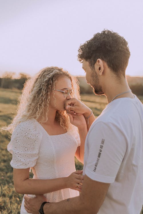 Couple Holding Hands and Kissing