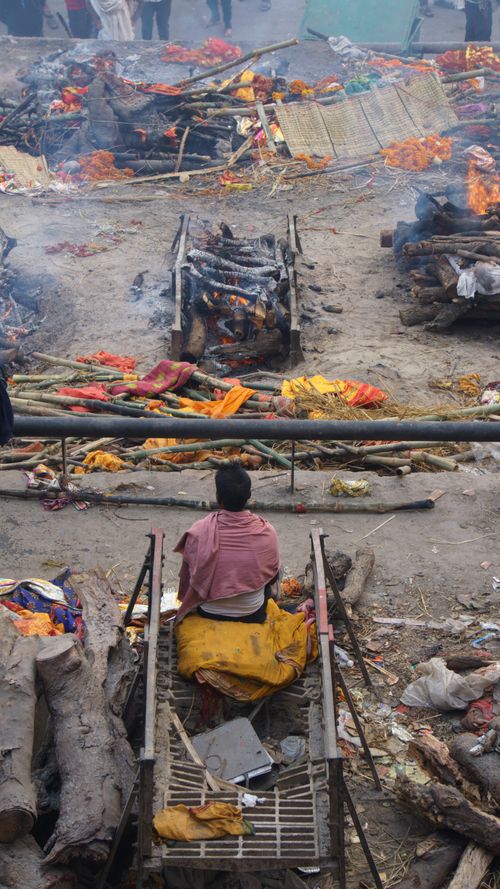 Free A solemn view of traditional cremation rituals taking place on the ghats of Varanasi, India Stock Photo