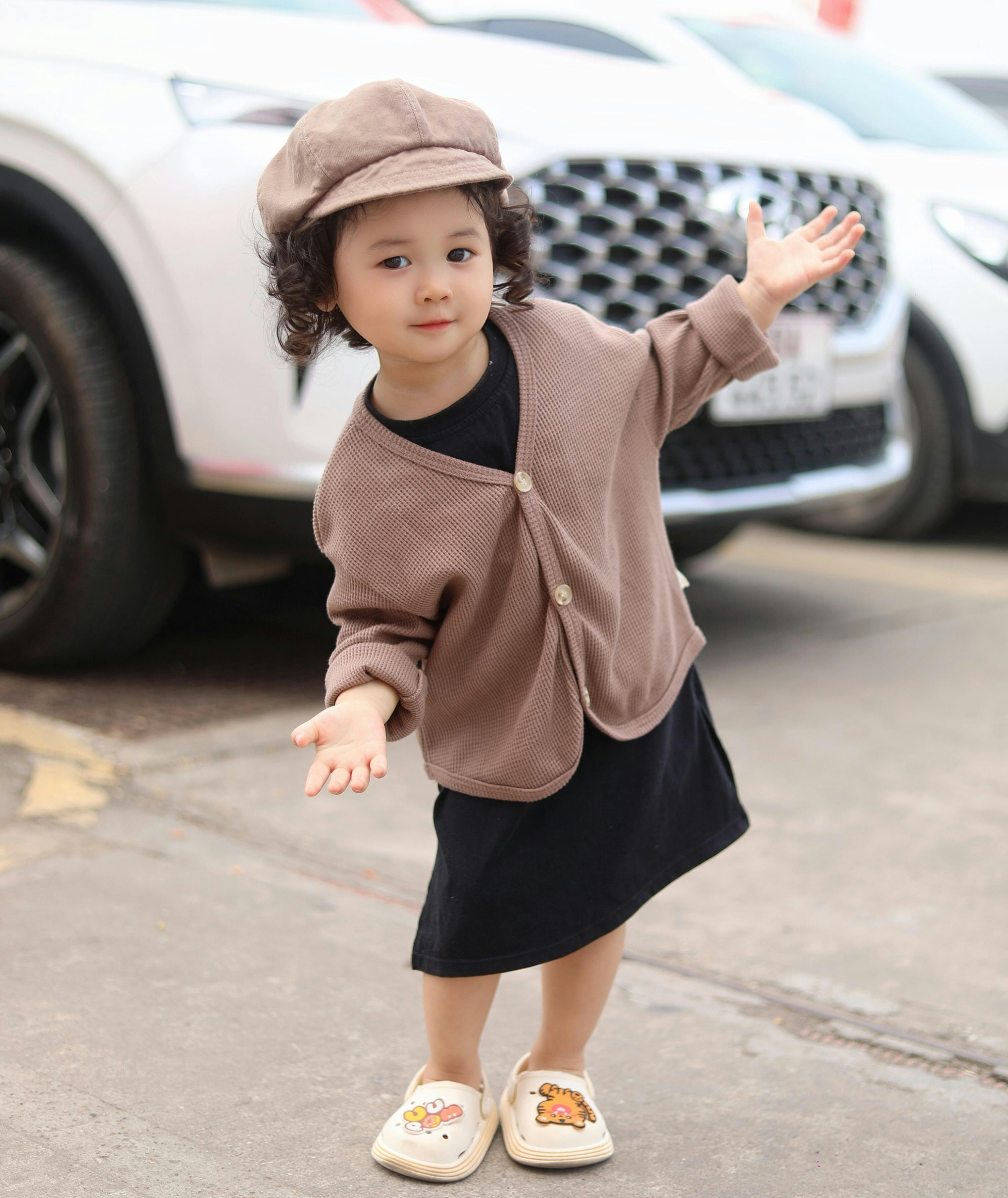 Cute Little Girl in Cardigan and Black Dress · Free Stock Photo