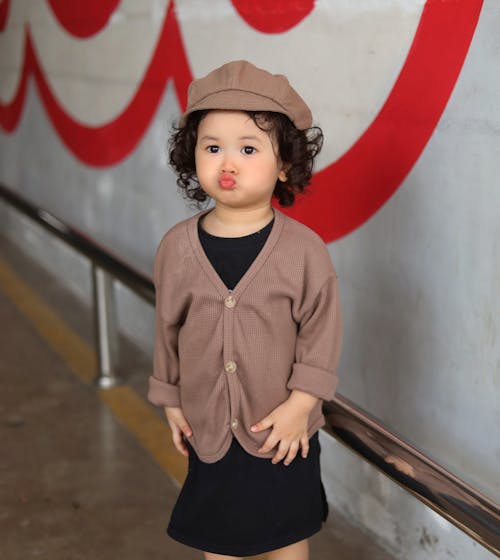 Free A Little Girl Making a Cute Facial Expression  Stock Photo