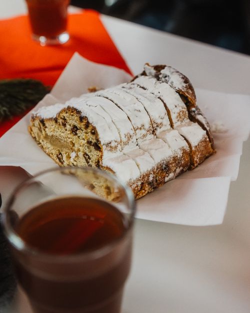 Free Tasty apple strudel with sugar topping on paper plate, perfect for dessert lovers. Stock Photo