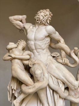 Marble sculpture of Laocoön and his sons at Vatican Museum, depicting a dramatic scene.