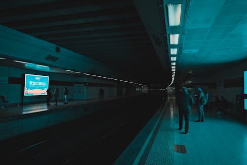 People on Subway Station in Dark Tunnel