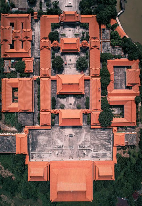 Free Aerial photograph showcasing the traditional architecture of a temple with orange roofs surrounded by greenery. Stock Photo