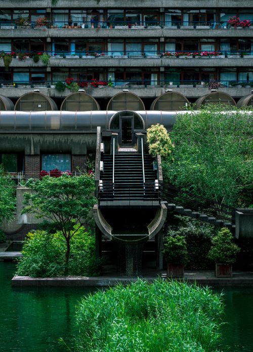 Free Explore the iconic urban design of London's Barbican Centre with its lush greenery and modern architecture. Stock Photo