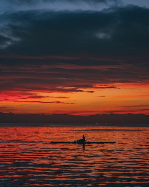 A Person on a Canoe at Sunset