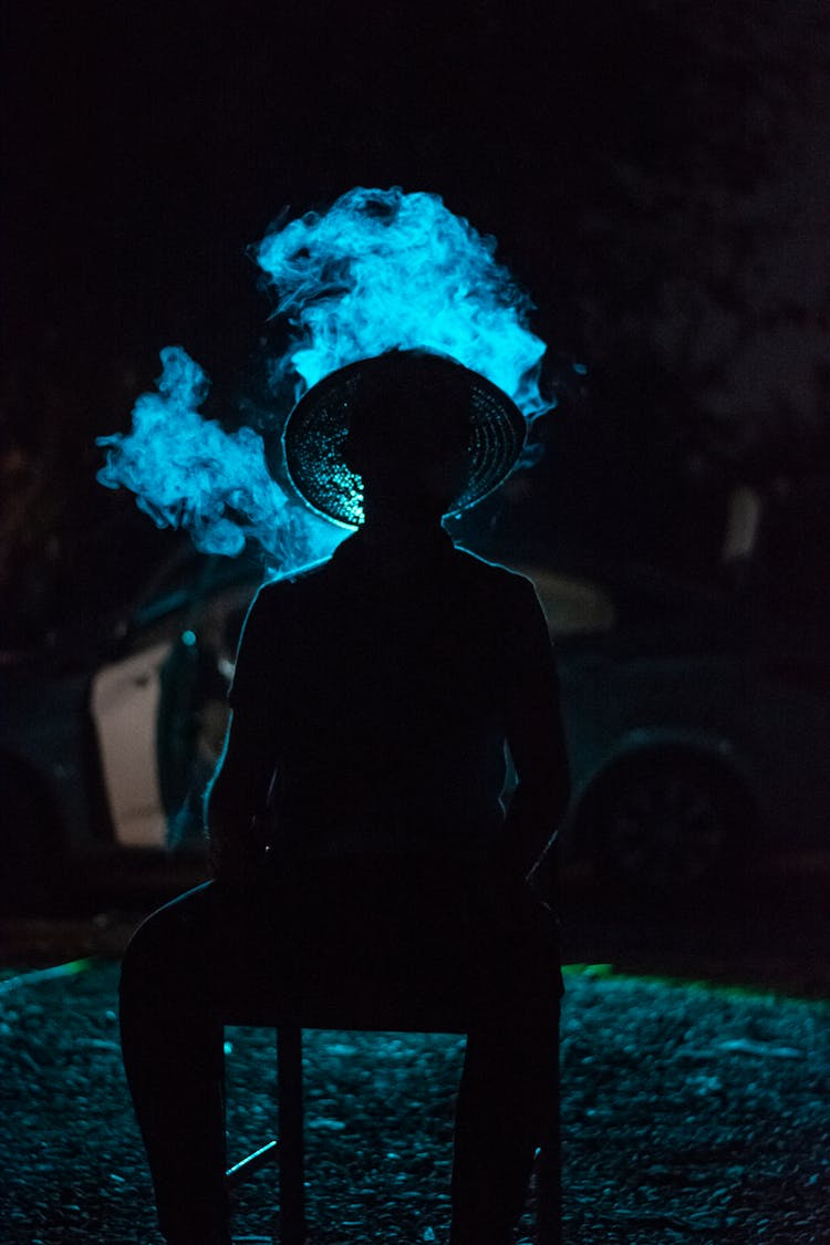 Silhouette Of A Man Sitting On A Chair 