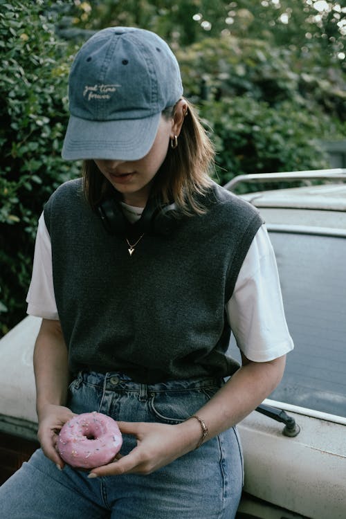 Woman in Cap Holding Donut