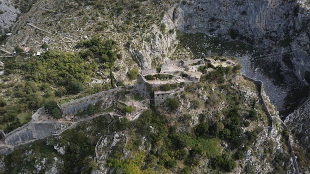 Stunning view of ancient fortification in Kotor, Montenegro from above. Perfect for travel and history themes.