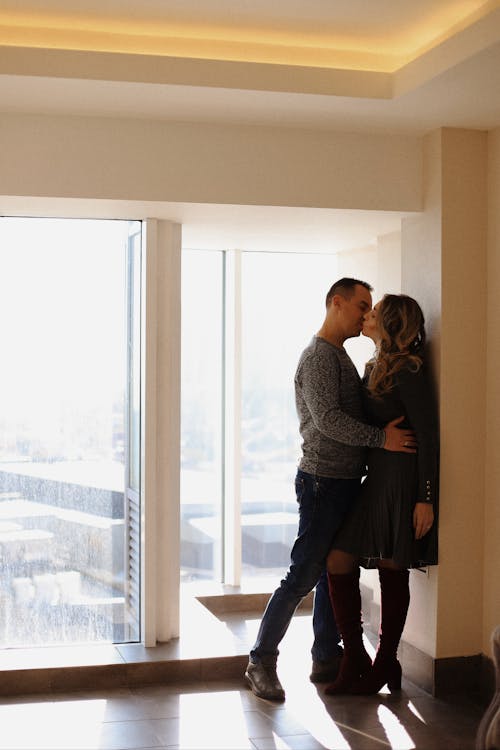 Young Couple Embracing and Kissing in a New Apartment