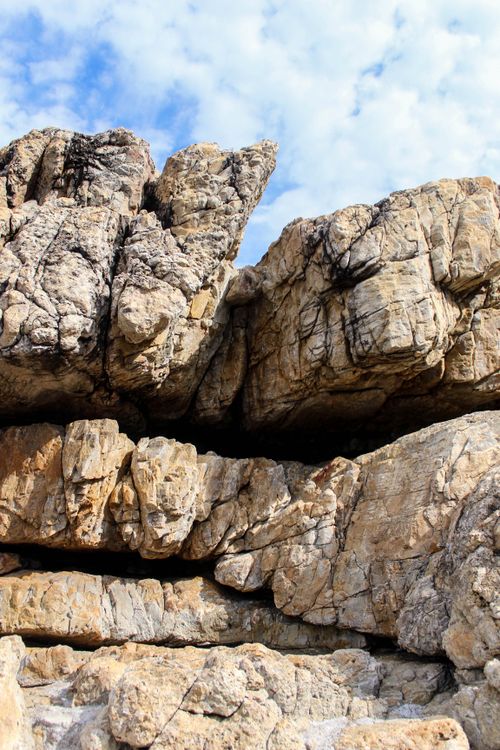 Free Stunning rock formations against a bright sky in Hermanus, Western Cape, South Africa. Stock Photo