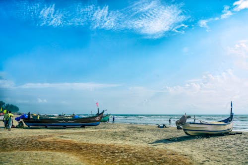 Free stock photo of beach landscape, blue sky, fishing boats