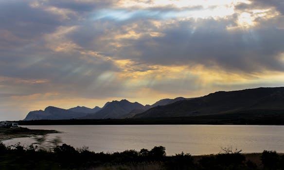 A breathtaking view of the sunset over the mountain range in Hermanus, South Africa.