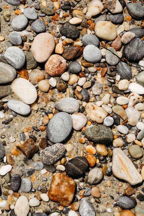 A close up of rocks and pebbles on the beach