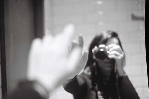 Free Black and white photo of a person taking a mirror reflection shot with a camera. Stock Photo