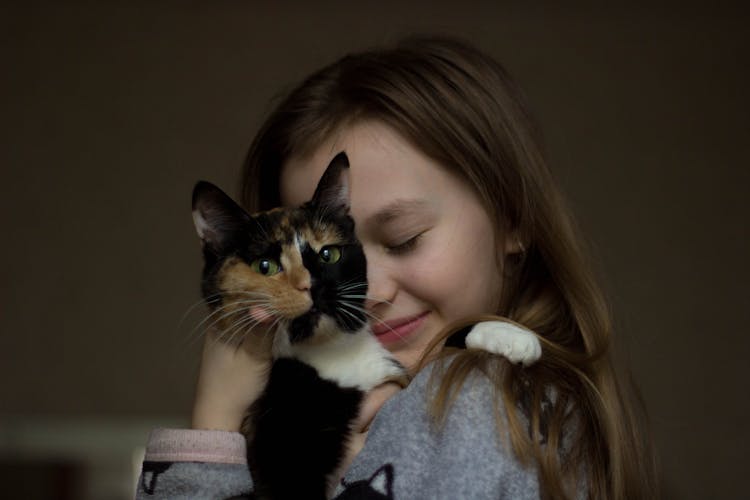 Cute Little Girl Tenderly Hugging Cat