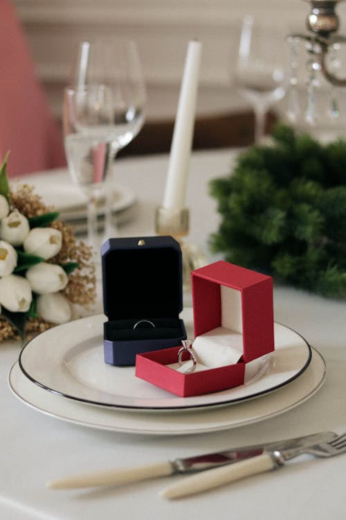 Close-up of Rings in Boxes Standing on a Plate on a Table