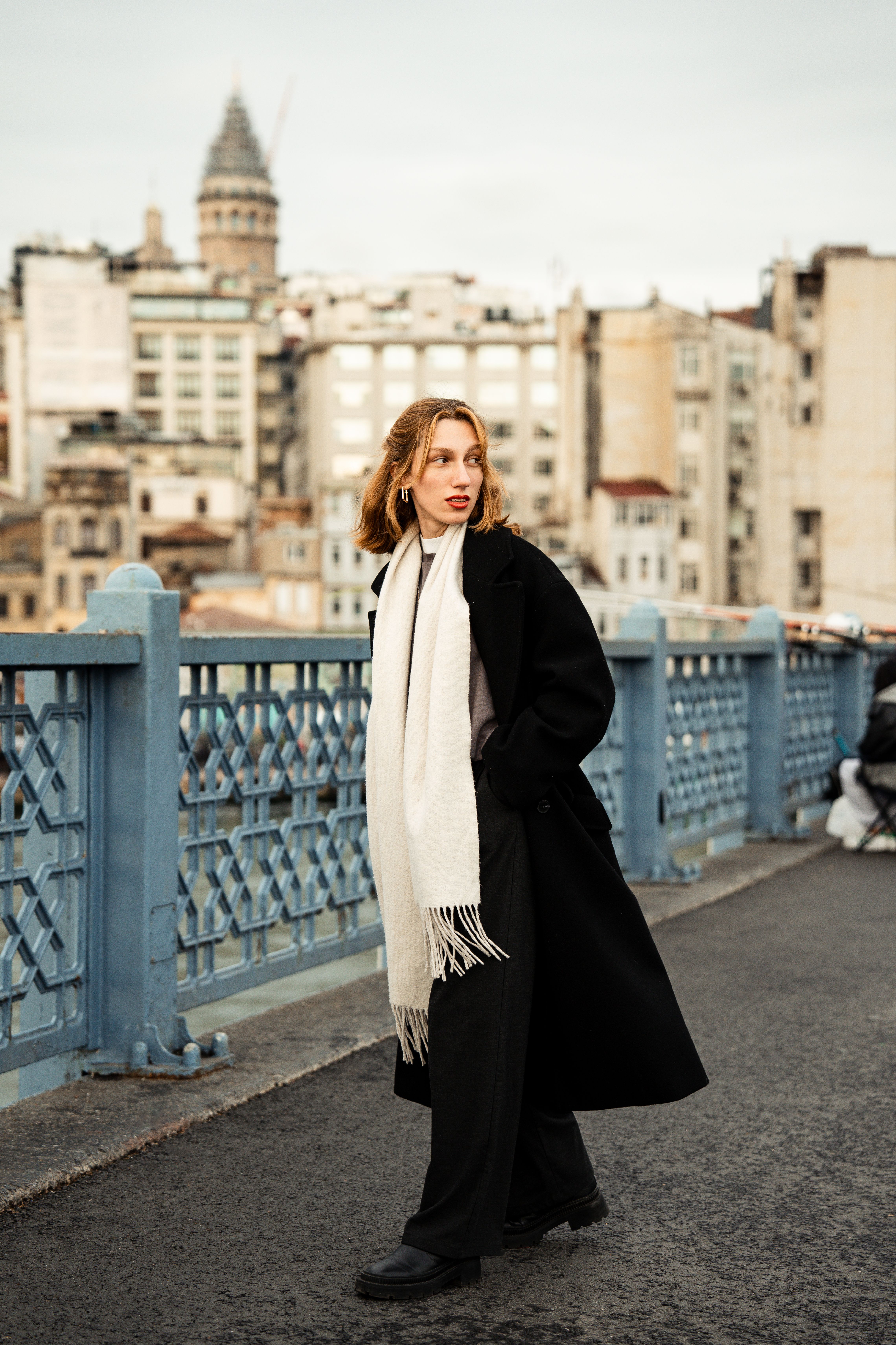 Elegant Woman in Black Coat on Bridge · Free Stock Photo