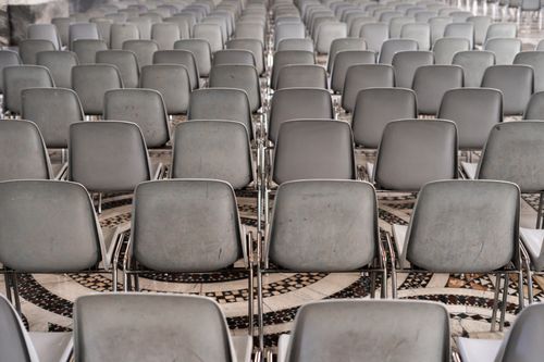 Free Symmetrical rows of empty chairs in a historic indoor auditorium. Stock Photo