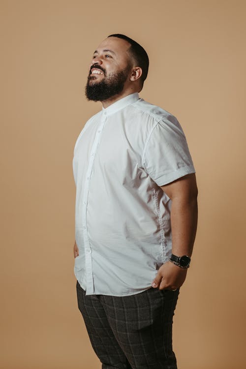 Studio Shot of a Bearded Man in a Shirt Standing and a Smiling 