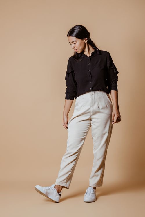 Free Stylish young woman posing in a studio wearing casual neutral-toned fashion. Stock Photo