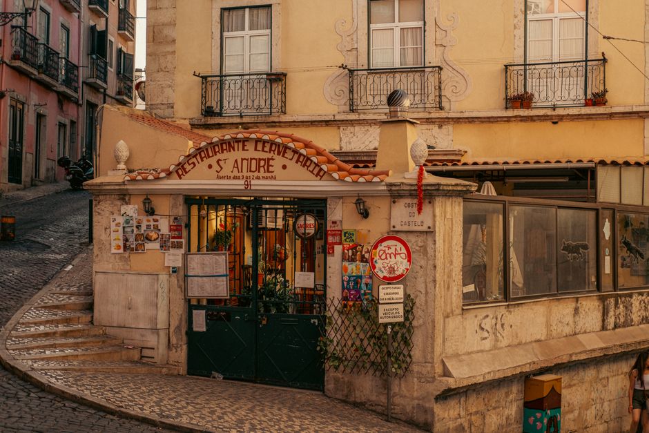 Charming corner restaurant in Lisbon's historic district exuding rustic European charm.