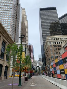Vibrant downtown Calgary street view featuring towering skyscrapers and urban architecture.