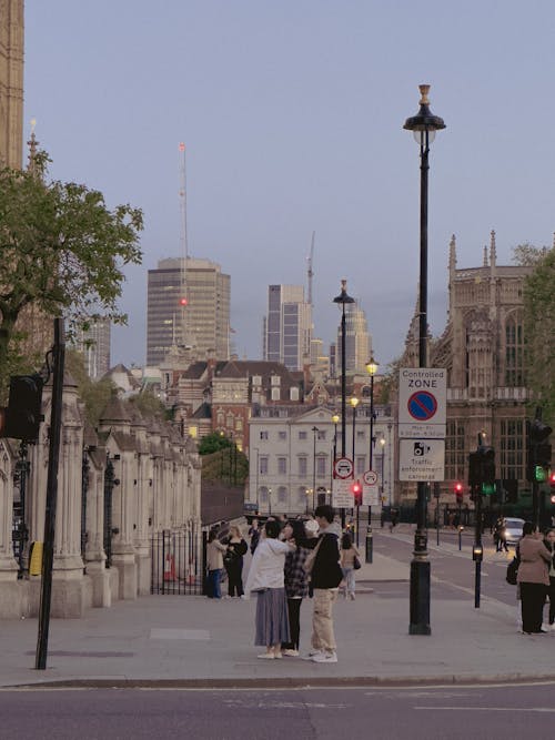 People Standing on a London Street in the Evening