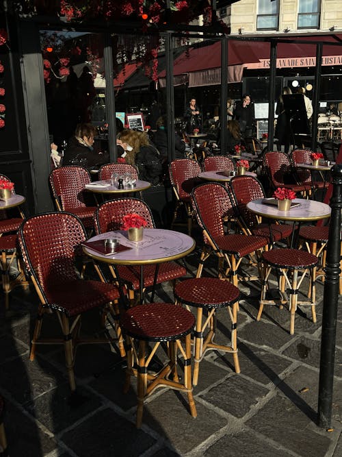 A restaurant with red and white tables and chairs