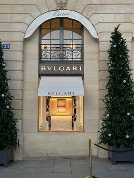 Front view of a luxury Bvlgari store adorned with Christmas trees, exuding elegance and festive charm.