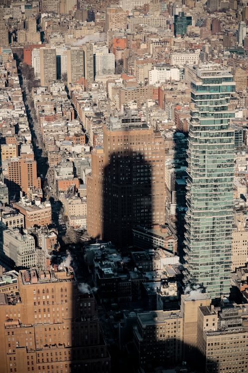 Modern skyscrapers in sunlight with huge shadow of neighboring building ...