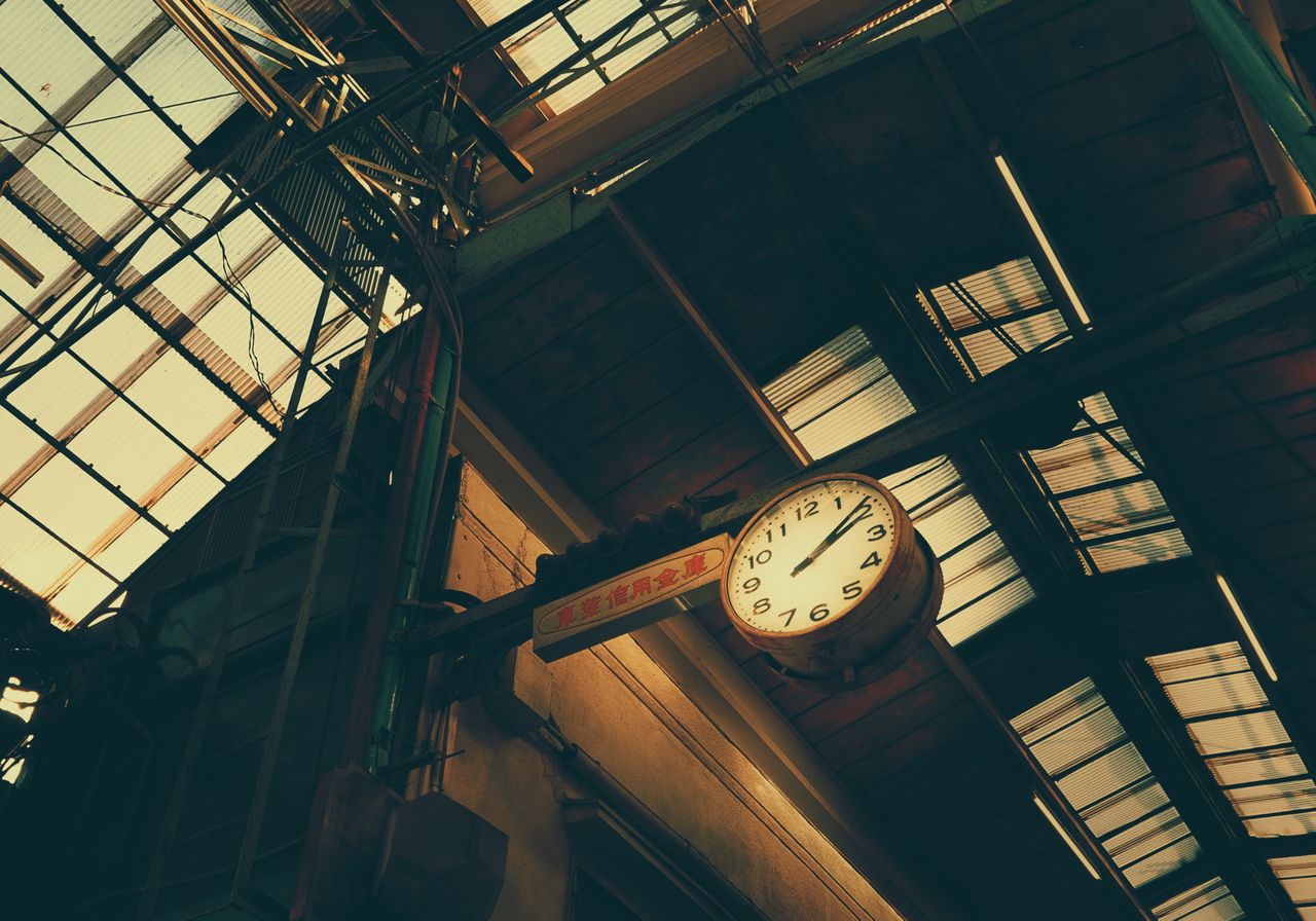 low angle view of a vintage clock in a japanese railway station with i