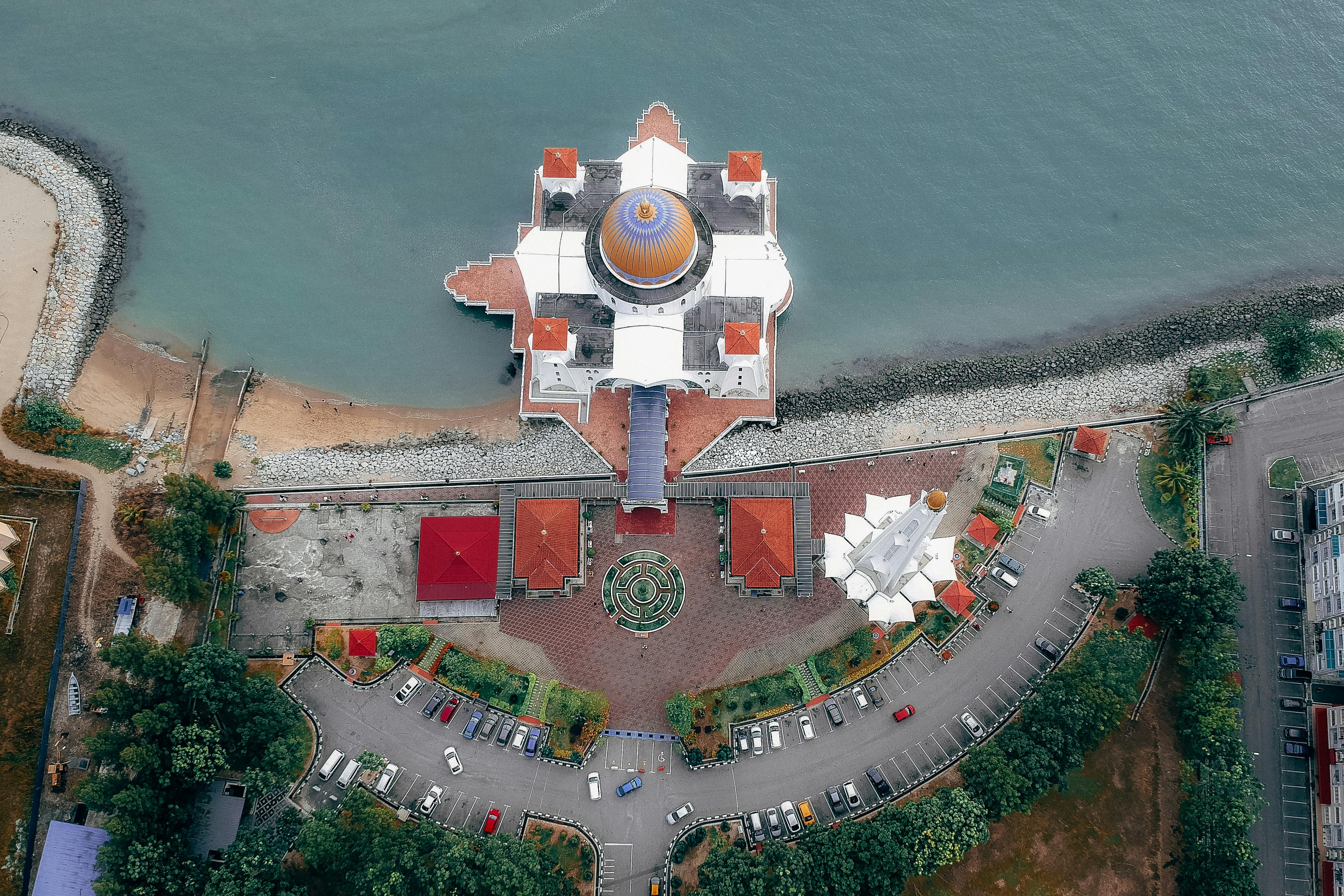 top view of mosque near body of water