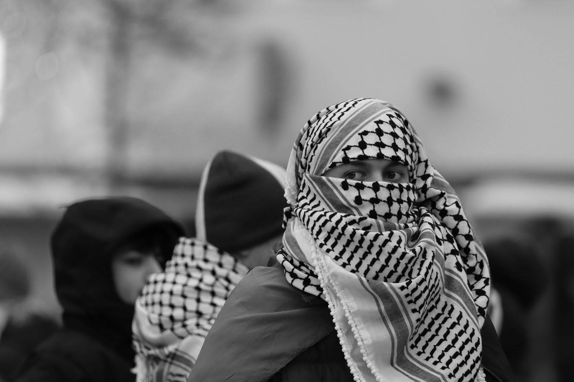 Black and white portrait of a peaceful protester wearing a keffiyeh in Jönköping, Sweden.