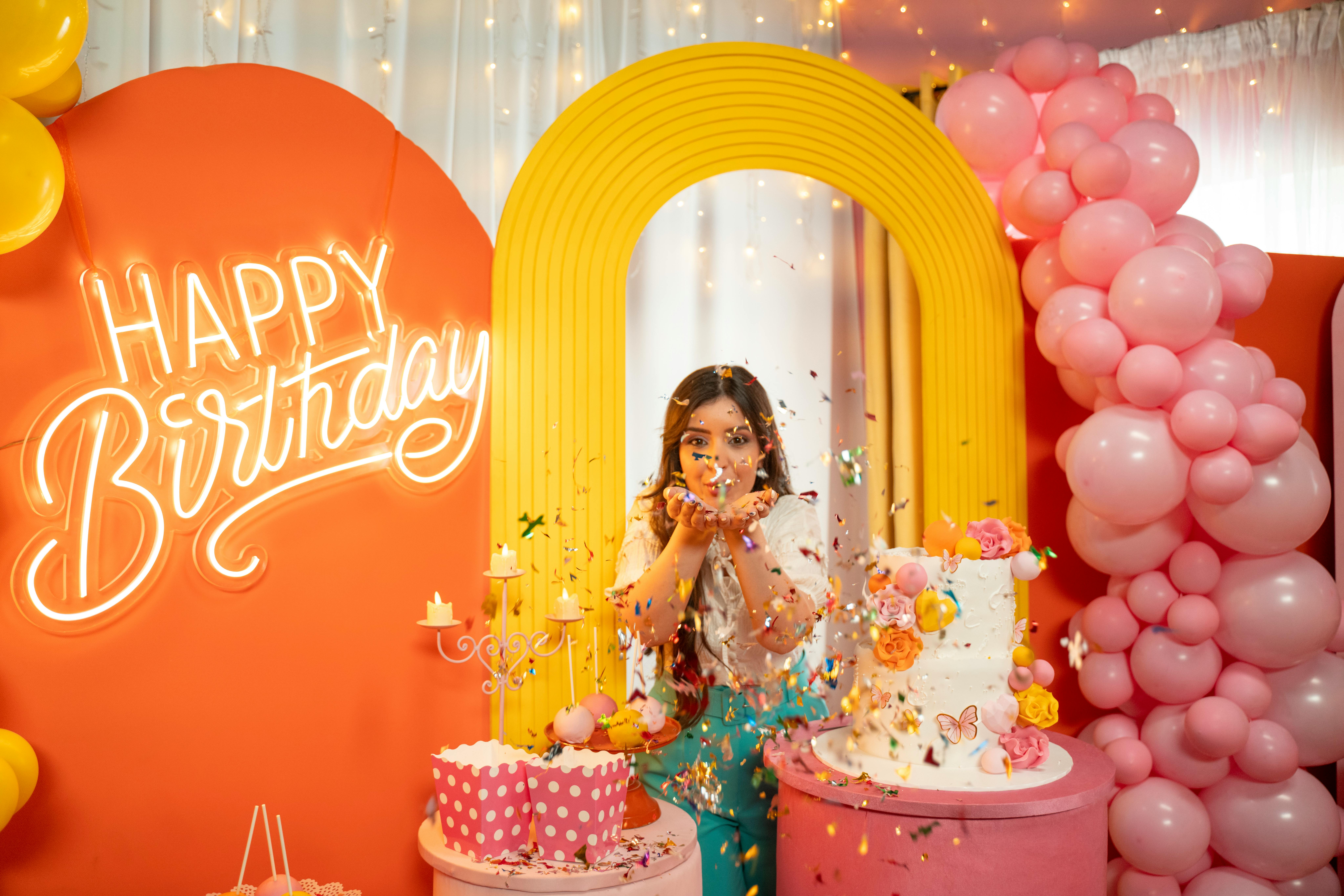 Young Woman Throwing Confetti between Birthday Decorations · Free Stock  Photo