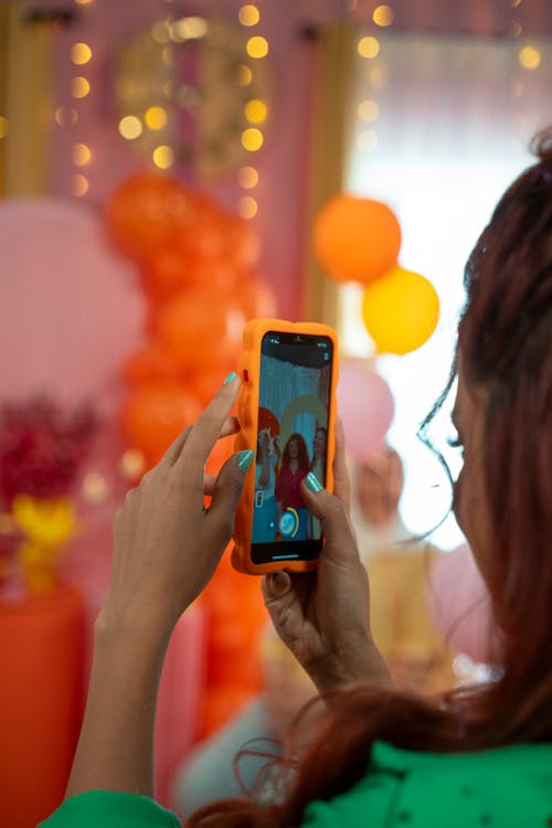 Woman Photographing Friends on Party