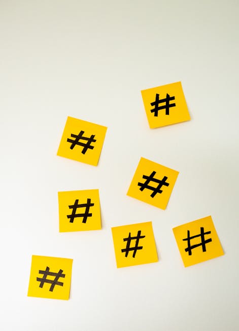 A close-up of yellow sticky notes with hashtag symbols, representing the various paths and strategies in the intricate marketing landscape, arranged on a clean white background.. Thanks to Walls.io for the photo