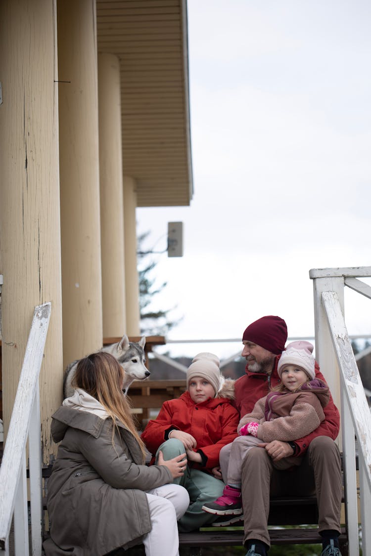 Family Sitting On Steps Outdoors