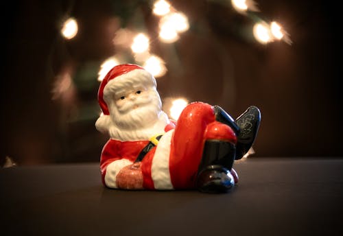 A figurine of santa claus sitting on a chair