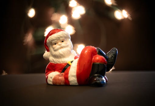 Ceramic Santa Claus figurine with twinkling lights, perfect for festive decoration.