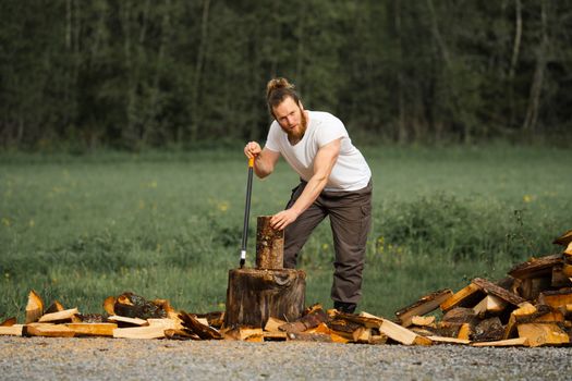 Man chopping wood outdoors, embodying classic lumberjack style and strength.