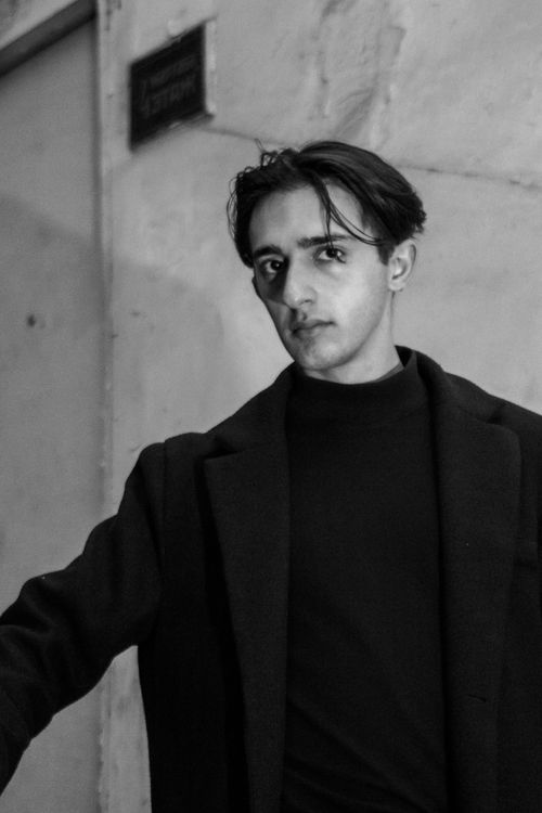Free Black and white portrait of a stylish young man in a coat. Stock Photo