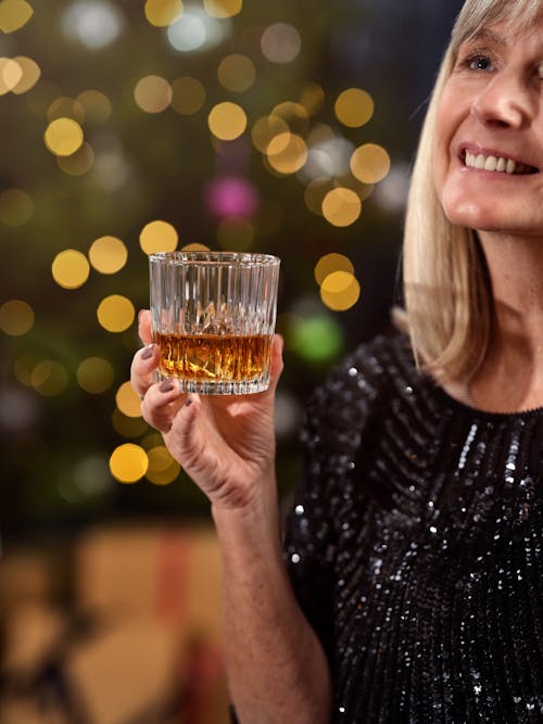 Woman Holding Glass of Drink in Hand